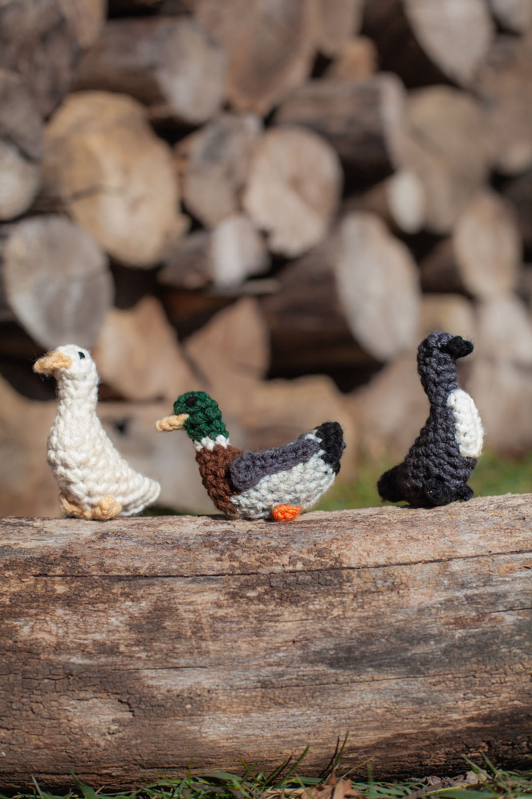 3 crochet little ducks perched on a log