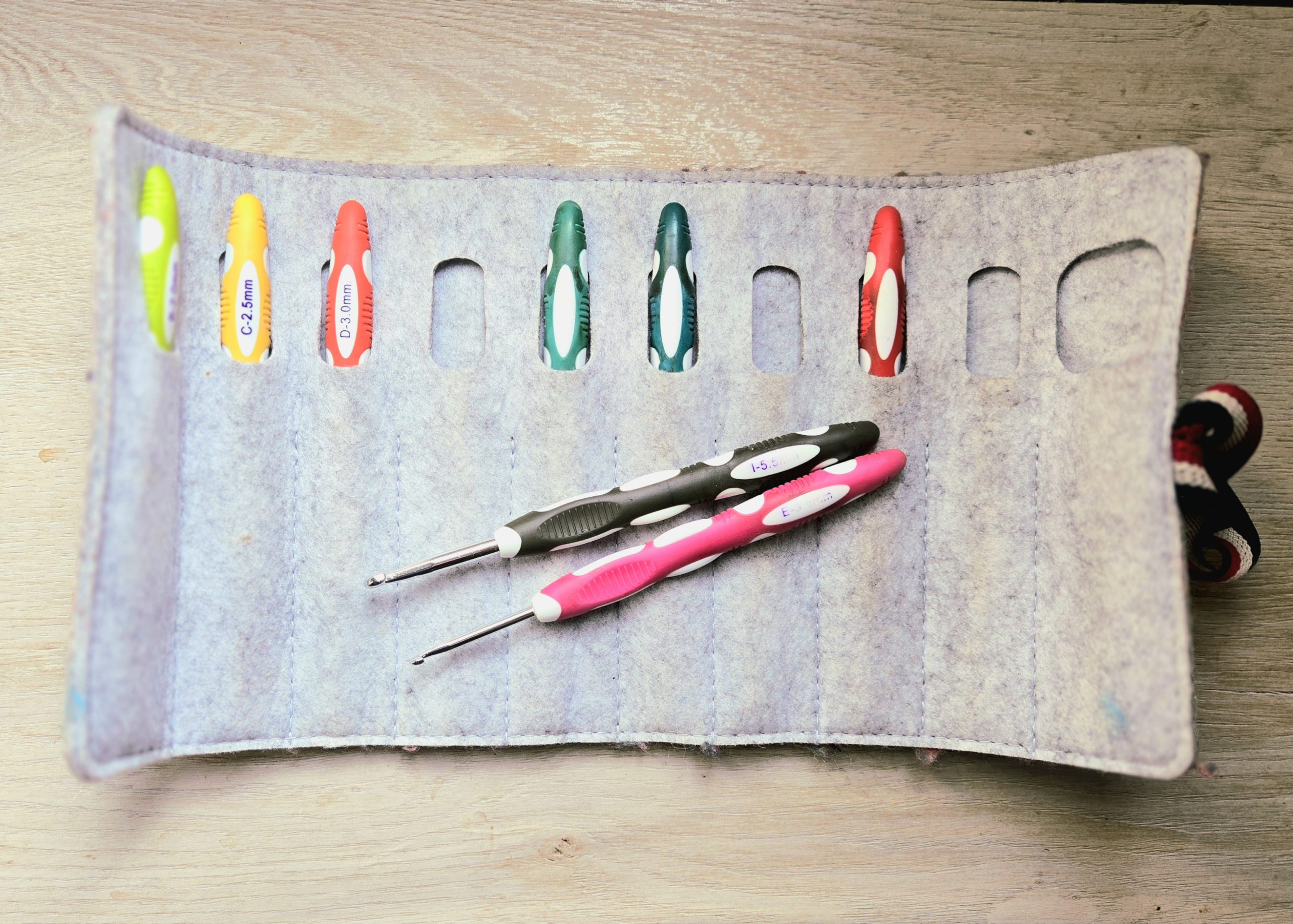 A pouch containing many hooks, with two on top.