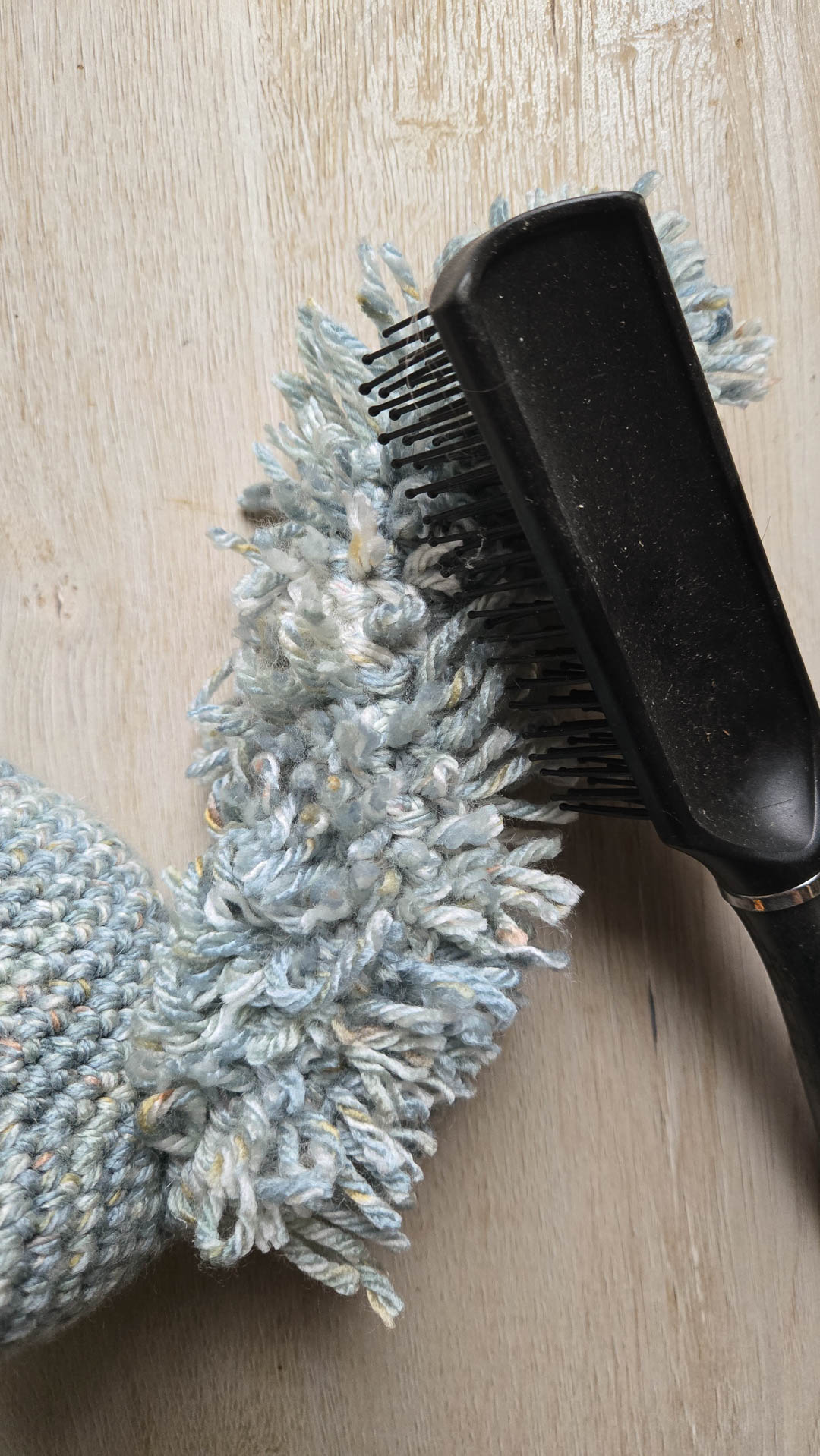 brushing out threads of yarn to teach how to crochet fur