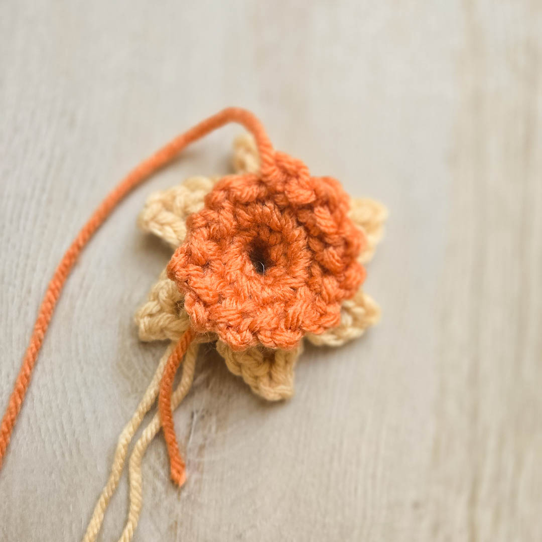 A yellow and orange daffodil made using this crochet daffodil pattern.