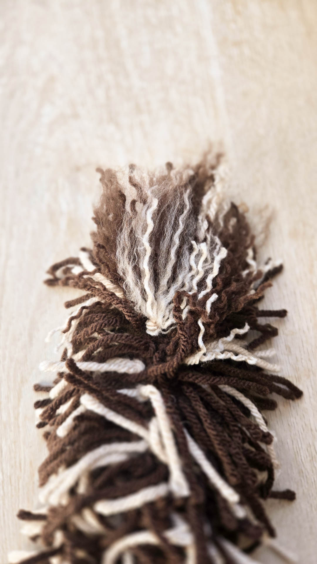 A small area of brown and tan threads brushed apart to make crochet fur.