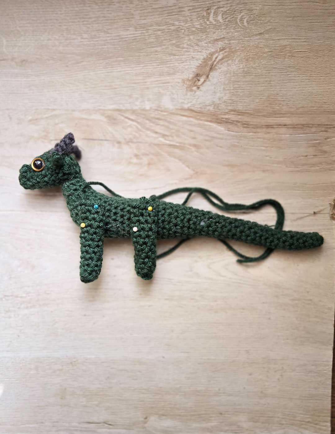 A green dragon being assembled.